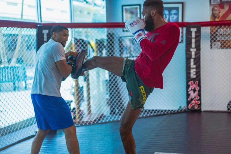 Dynamic kickboxing training session featuring two athletes in action inside a gym.