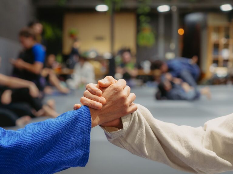 Two jiu-jitsu practitioners shake hands in a dojo during training in Buenos Aires, Argentina.