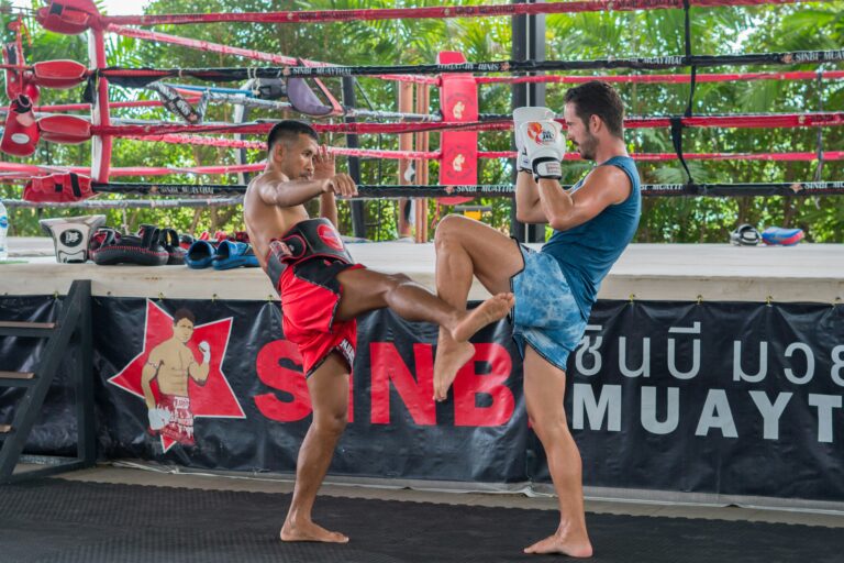 a couple of men standing next to each other in a boxing ring